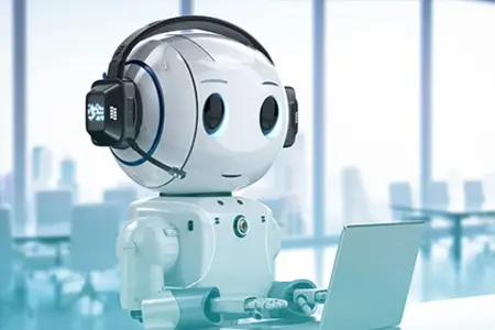 A humanoid robot with a headset works on a laptop in a modern office.