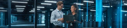 GOB’s digitalisation consultancy – Identifying opportunities and shaping change Illustrative image: Two consultants with laptop by server racks for GOB digitalisation consultancy.