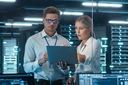 Illustrative image: Team checks servers on laptop for GOB infrastructure analysis at client site.