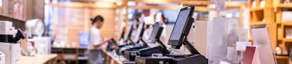 Checkout workstations with modern POS systems in retail