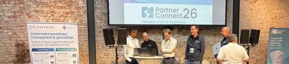 PartnerConnect26: Neuerungen aus den CKL-Modulen Mehrere Personen stehen vor einer Präsentationsfläche auf der PartnerConnect26.