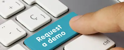 Header image for demo request form. Focus on wide turquoise shift key on grey keyboard, renamed in "Request a demo".