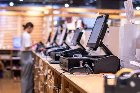 Checkout workstations with modern POS systems in retail