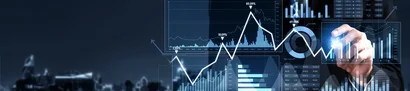 Business person uses a tablet with digital sales charts and data visualisations