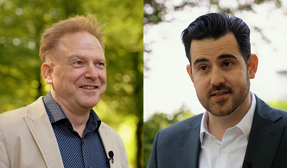 Zwei Experten unterhalten sich im Freien; darüber liegen die Worte „Walk and Talk“.