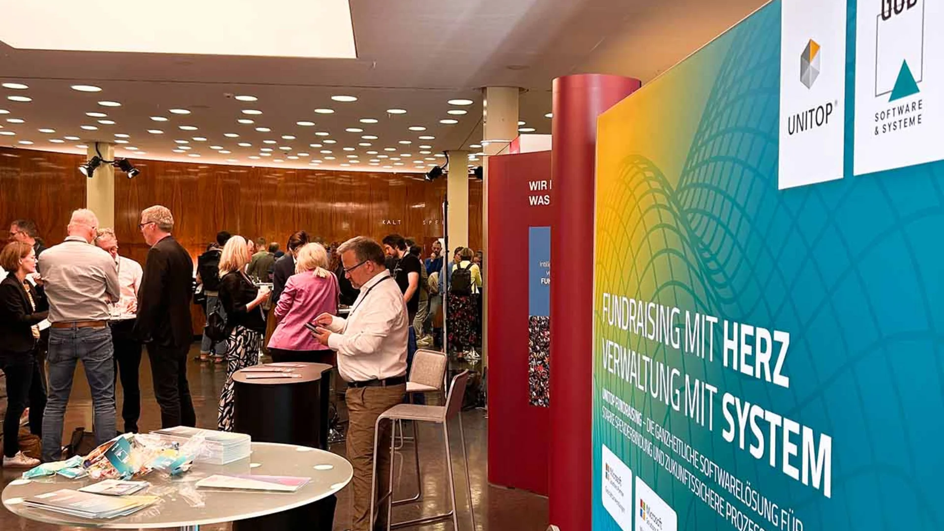GOB-Infostand auf dem DFK 2025 mit Teilnehmenden im Gespräch und Infomaterialien im Vordergrund