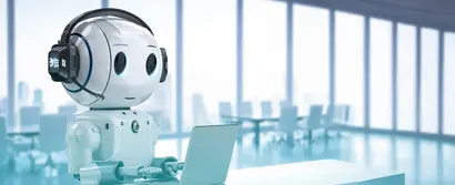 A humanoid robot with a headset works on a laptop in a modern office.