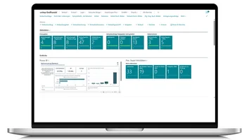 Laptop with roll centre from unitop ERP solution for wholesale tile distribution and Power BI view.