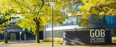 Front view of the GOB building with trees with autumnal yellow leaves